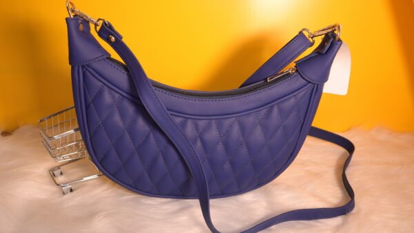 Quilted leather moon shaped Blue sling bag