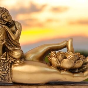 Golden scripture depicting Gautam buddha resting on the wrist of a hand making dhyaan mudra with thumb and fingers moreover a lotus shape stand placed on the palm.