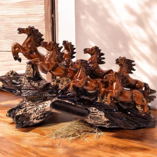 Sculpture of seven brown horses running on a rock made up of polyresin