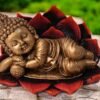 A beautiful statue of baby buddha sleeping on a lotus made up of polyresin
