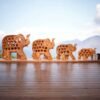 Elephant family sculptures having mesh body madeup of wood.