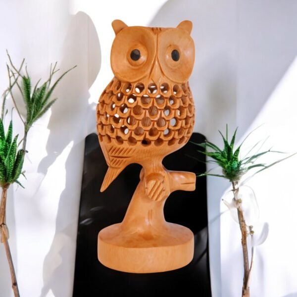 Wood side facing owl carved from single piece of wood